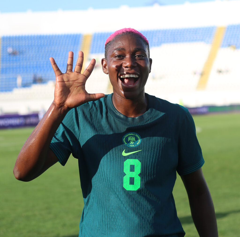 Asisat Oshoala shows five fingers to represent Nigeria's goals
